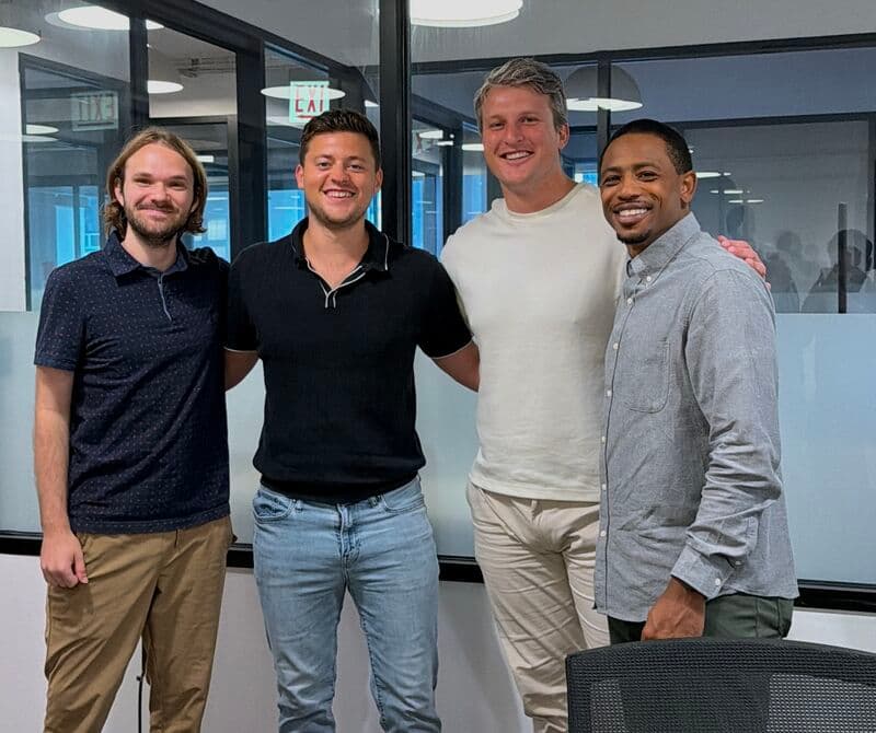 Four members of the Objectionly team standing together in an office